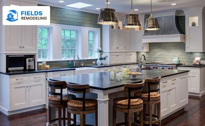 Industrial-style kitchen with wooden flooring, marble countertops, and stylish chairs, perfect for hosting gatherings.